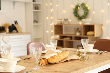Christmas table setting with bread in kitchen, closeup