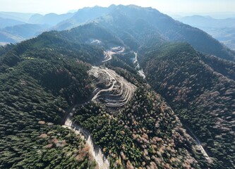 Industrial mine excavators are digging the soil in the construction site and loading trucks. Aerial...