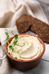 Delicious hummus served on white wooden table