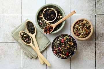 Many different herbal teas on white tiled surface, flat lay