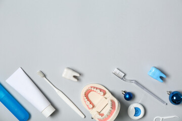 Dentist's supplies with Christmas balls on grey background