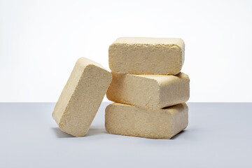 Briquettes made of pressed sawdust on the table.  concept of biomass heating.