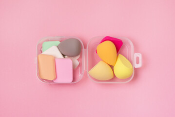 Box with Colored Beauty Blenders and Sponges for Make Up Top View Pink Background