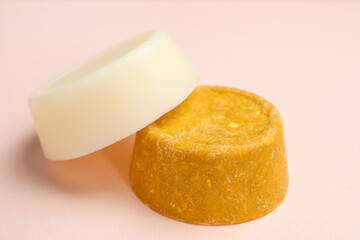 Solid shampoo bars on pink background, closeup. Hair care