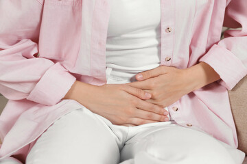 Woman suffering from cystitis at home, closeup