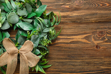 Stylish Christmas wreath on wooden background, closeup