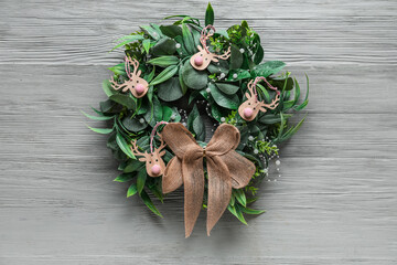 Stylish Christmas wreath on grey wooden background