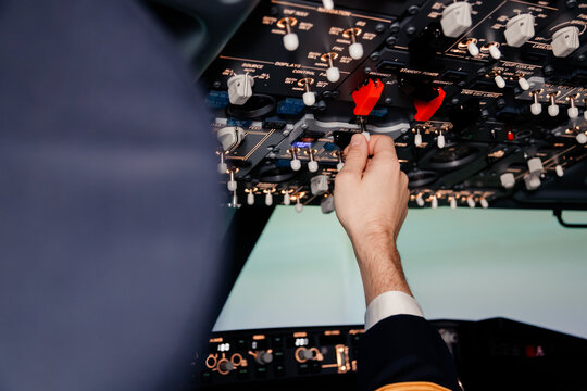 Pilot hand is controlling plane toggle switches to fly take off and landing