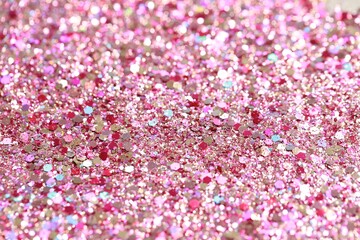 Beautiful pink shiny glitter as background, closeup