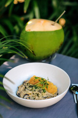 Plate with risotto at the table, outdoors