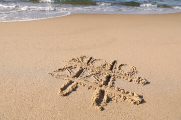 Tic tac toe game drawn on sand near sea, space for text