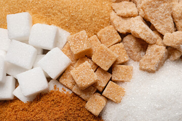Different types of sugar as background, closeup