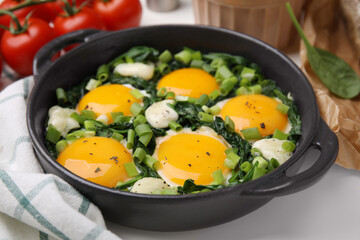 Tasty green Shakshouka served on white table, closeup
