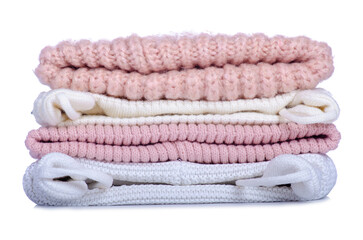 Stack of warm hats on white background isolation