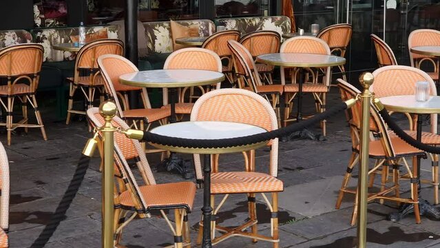 Sidewalk cafe  with small round tables and empty chairs - coffeehouse, coffee shop, diner or restaurant.