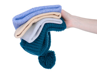 Stack of warm hats in hand on white background isolation
