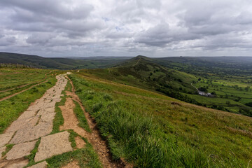 On the footpath along Mam Tor ridgeline as rain clouds move in.