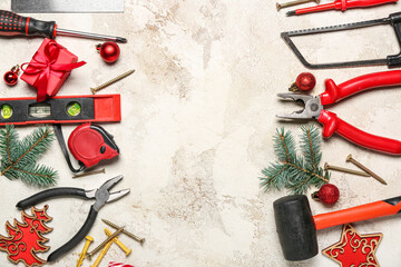 Frame made of worker's tools, Christmas decor and gift on grunge background