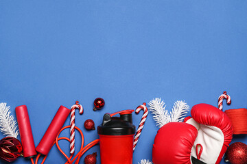 Sports equipment with boxing gloves and Christmas decor on blue background