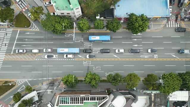 Looking down at road traffics with cars and buses on the day, in Daegu city, Korea