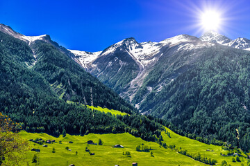 Fototapeta na wymiar Fields with houses in Swiss Alps mountains, Moerel, Filet, Oestlich Raron, Switzerland