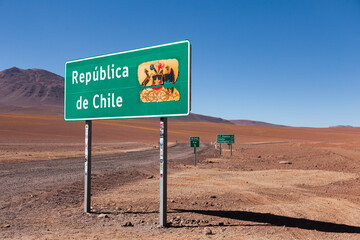 Republic of Chile sign, with its motto By Reason or Force seen next to dirt road near the Bolivian...