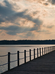 Late afternoon over a pier. Blue and orange sky over a lake. Late afternoon over a lake side.