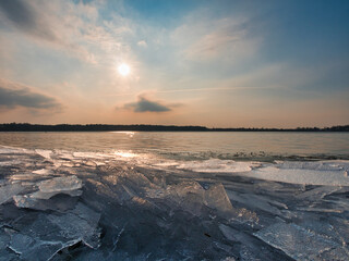 Ice stacks over the sunset lake. Sunset over the frozen lake. ice mountains on the lake shore