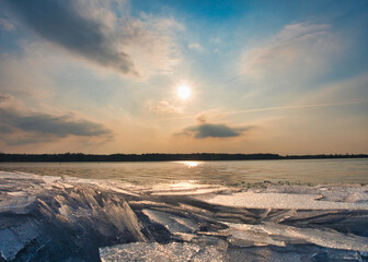 Ice stacks over the sunset lake. Sunset over the frozen lake. ice mountains on the lake shore