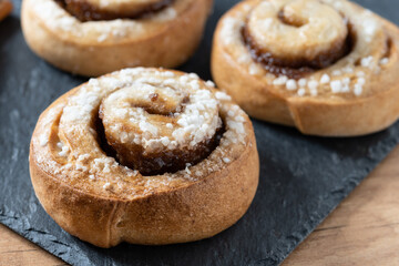 Cinnamon rolls buns on wooden table. Kanelbulle Swedish dessert