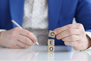 Businessman collecting words seo with wooden blocks