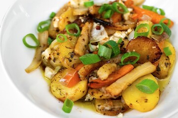 Fried vegetable on plate on white background, closeup.