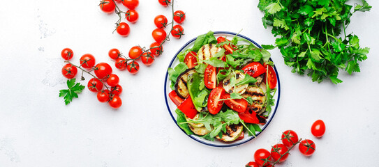 Healthy vegan salad with grilled vegetables, paprika, zucchini, eggplant with fresh tomatoes and...