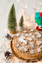 Fototapeta na wymiar Christmas cake with your own hands. Christmas composition with homemade cake. Vertical photo. Christmas cookies with cinnamon and christmas tree.