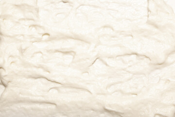 Cake cream texture, sweet whipped cream. Background of yogurt close-up with a pattern.
