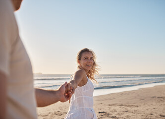Fototapeta na wymiar Couple holding hands on the beach and walking together for outdoor wellness, summer holiday and vacation by the sea. Love, happy and travel woman or people by the ocean, horizon and blue sky mockup