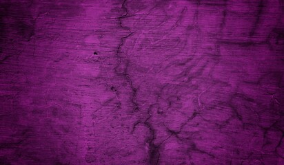 A textured purple concrete wall with a prominent vertical crack. 