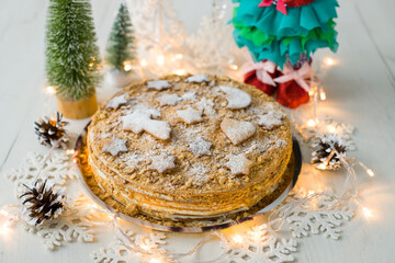 A beautiful Christmas cake decorated with gingerbread. Christmas homemade cake. Honey cake.