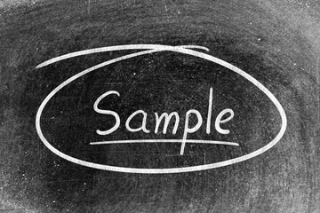 Fototapeta premium White chalk hand writing in word sample on blackboard background