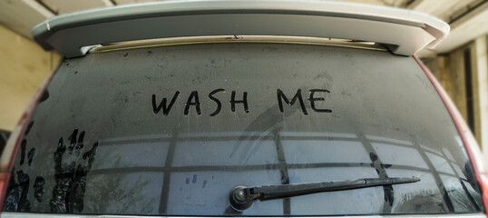 Wash me - A very dirty car. Close-up of car dust with inscription 
