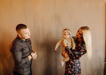 Portrait of a young family in the studio