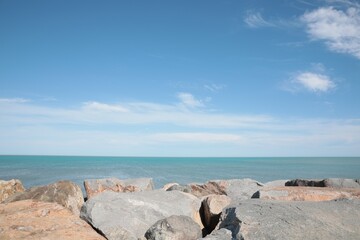 Fototapeta na wymiar Picturesque view of beautiful rocky seacoast on sunny day