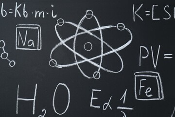 Fototapeta na wymiar Different chemical formulas written with chalk on blackboard, closeup