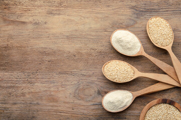 Spoons with quinoa flour and seeds on wooden table, flat lay. Space for text