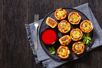 sloppy joe cups on black plate, top view