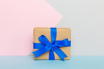 holiday handmade paper present tied blue ribbon bow top view with copy space. Flat lay holiday background. Birthday or christmas present. Christmas gift box concept with copy space