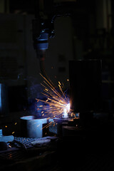 Industrial robots are welding in a car body factory,The concept of using robots to work instead of...