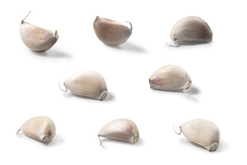 garlic cloves shape laying on a white