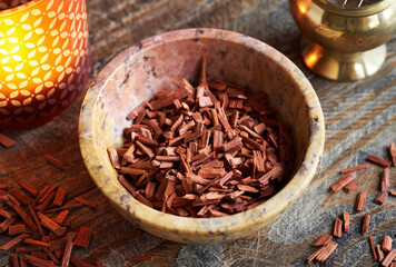 Red sandalwood chips in a bowl on a table