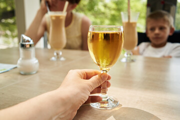 Family with children eating and drinking at a restaurant